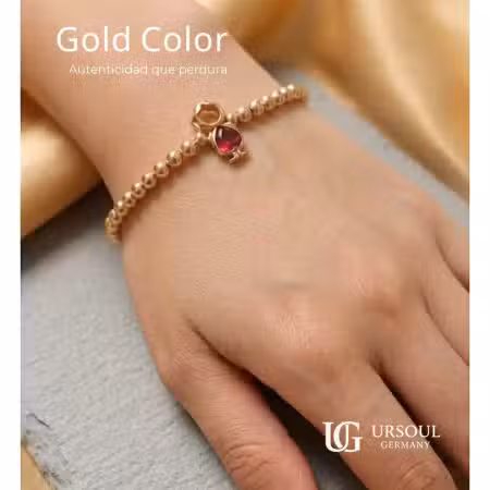 Pulsera para dama Gold Color con figura de niña y cristal rojo de Ursoul Germany